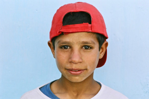 Afghan boy red cap