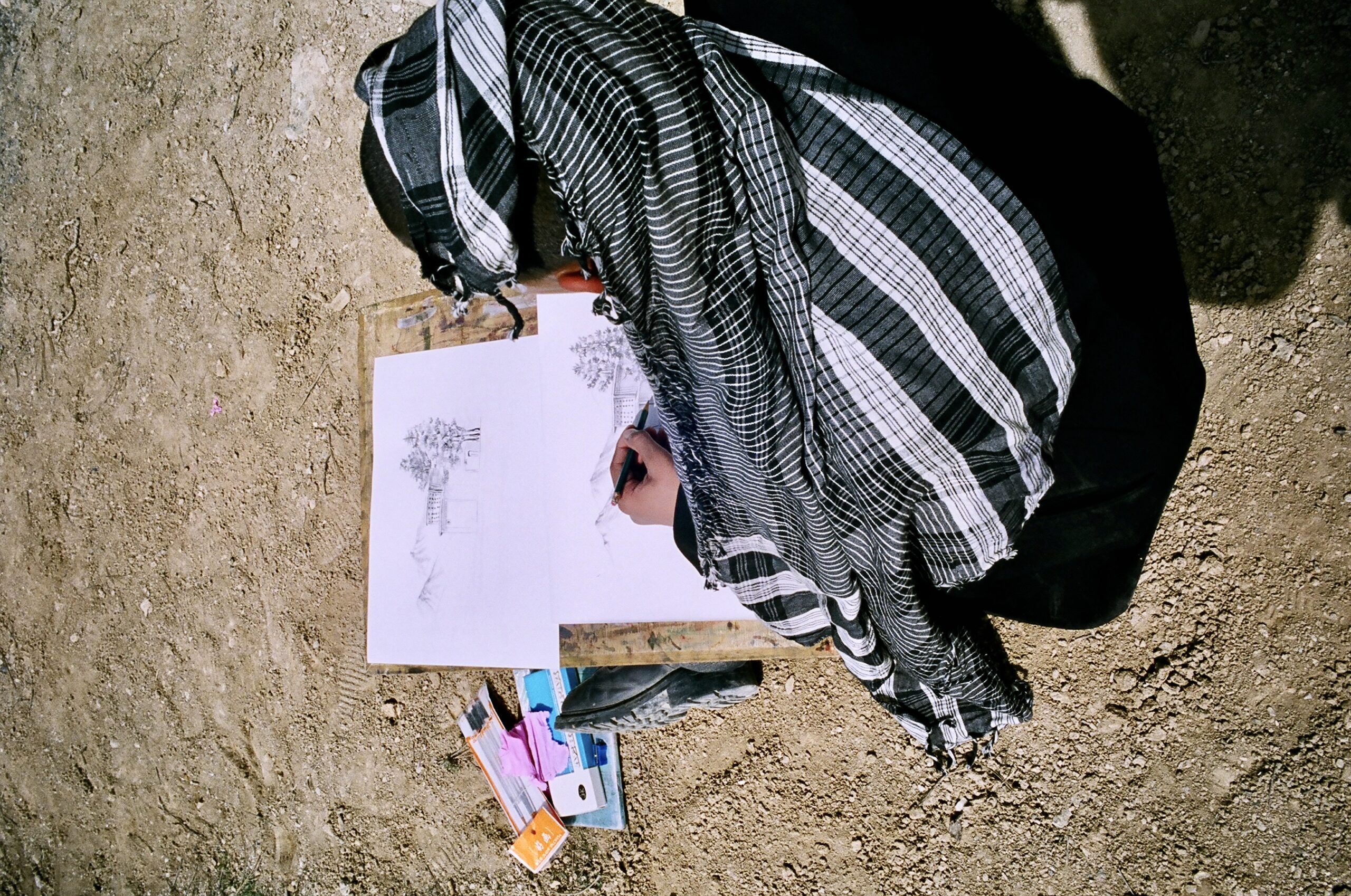 Afghan teen artist drawing a landscape
