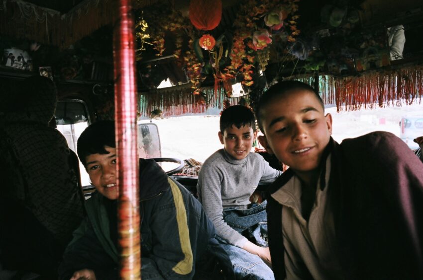 Three Afghan boys interior Pakistani bus