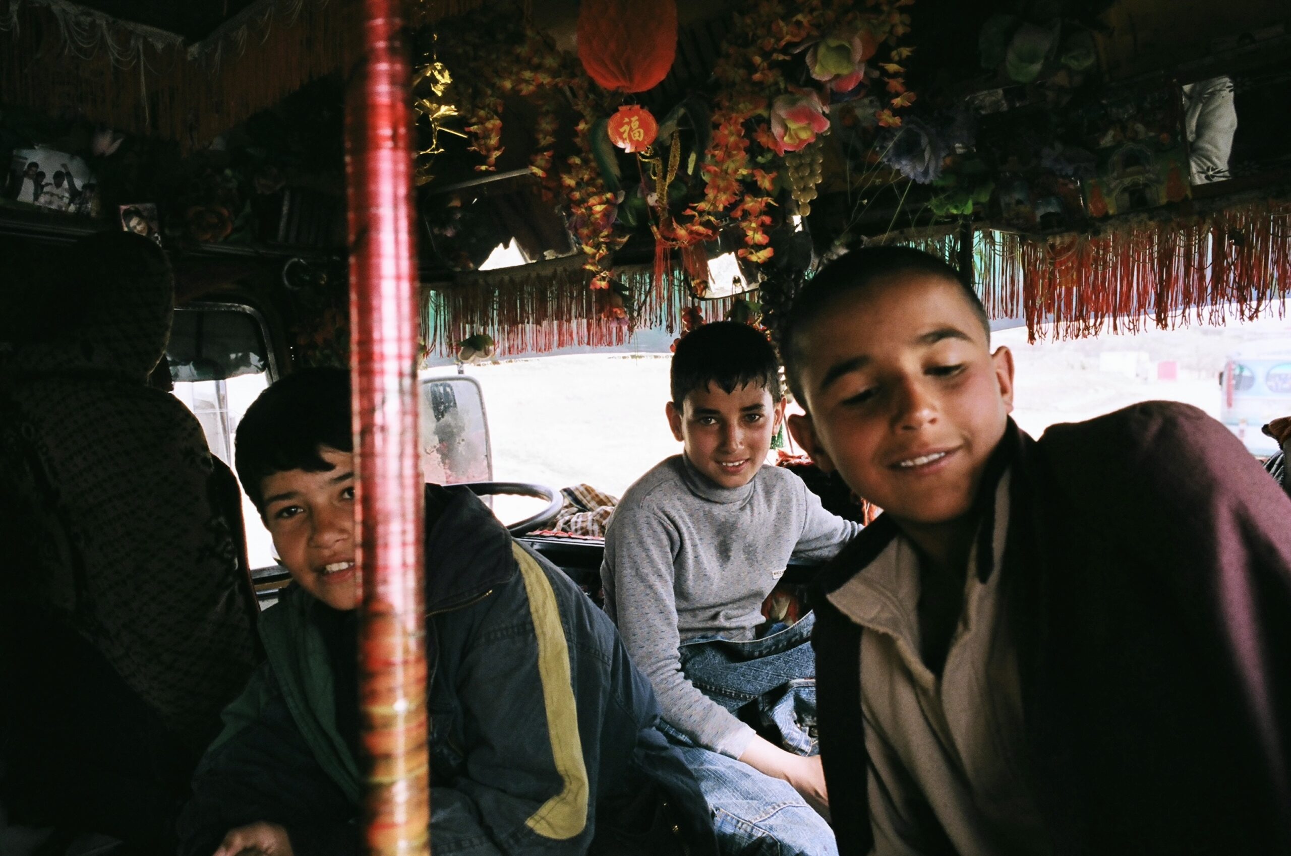 Three Afghan boys interior Pakistani bus